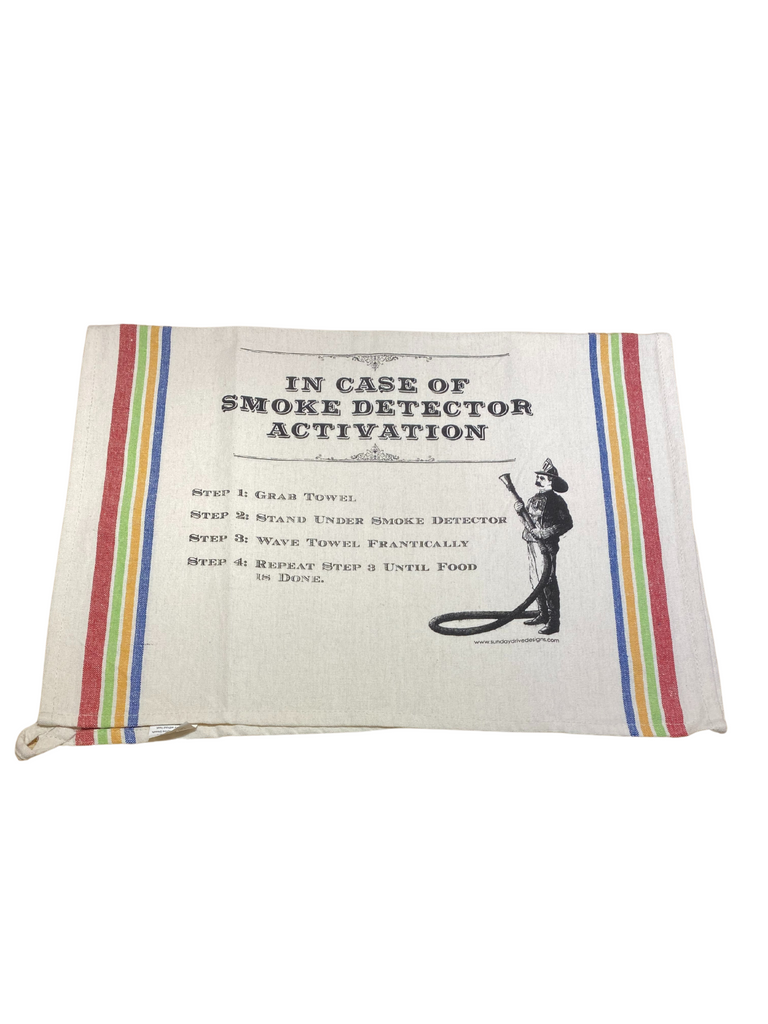 Vintage Firefighter with hose graphic on natural colored tea towel with blue, yellow, green, red stripes on either side. Design printed on replica towels that were inspired by the kitchen linens found in many homes from the late 1920's through the 1940's. Towel measurements are 18-inch by 28-inch, 100-percent cotton, and hemmed on all sides.